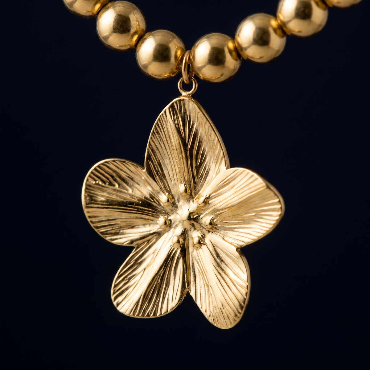 Collier fleur sur chaîne à boules, motif en gros plan