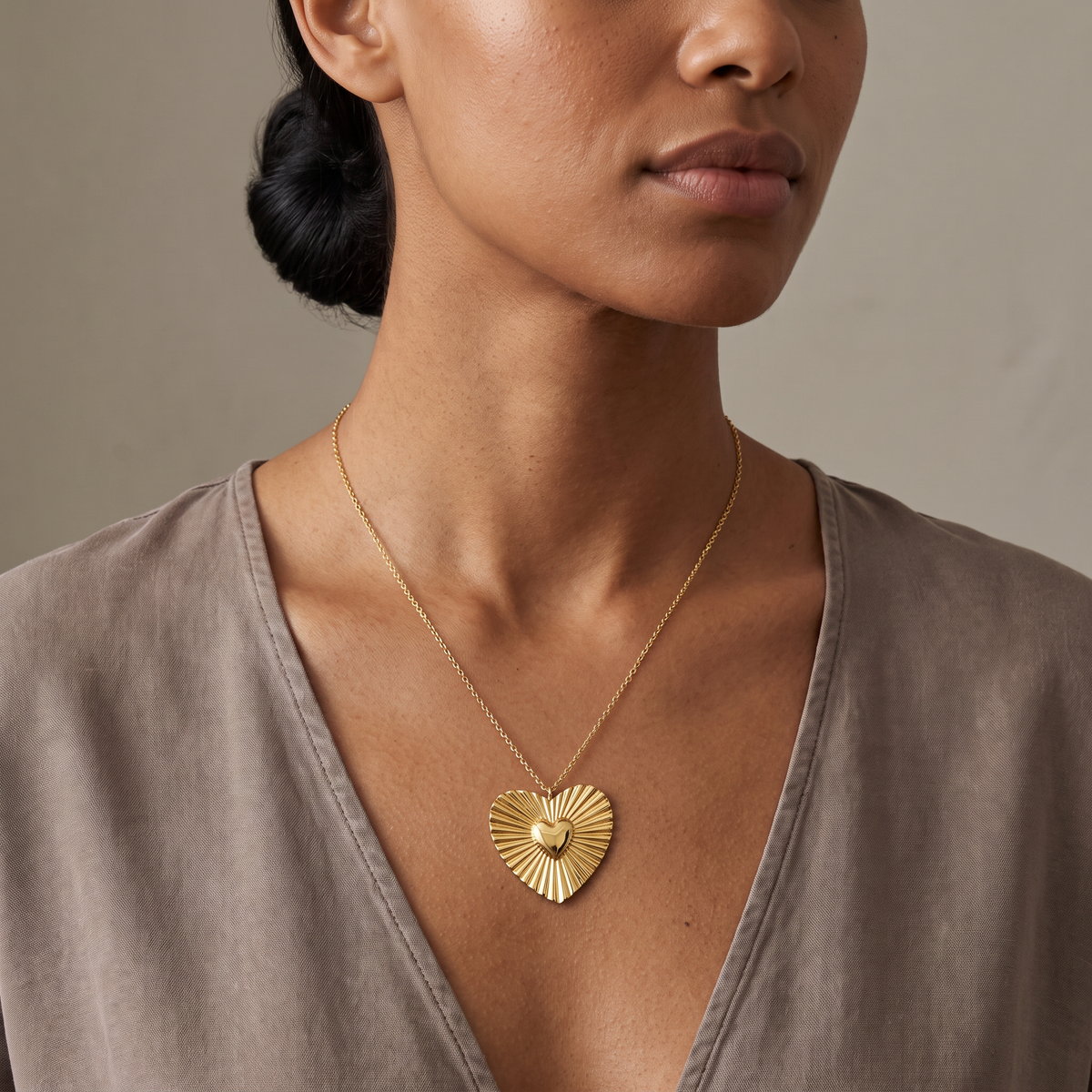 Collier cœur doré rayonnant, porté mi-corps