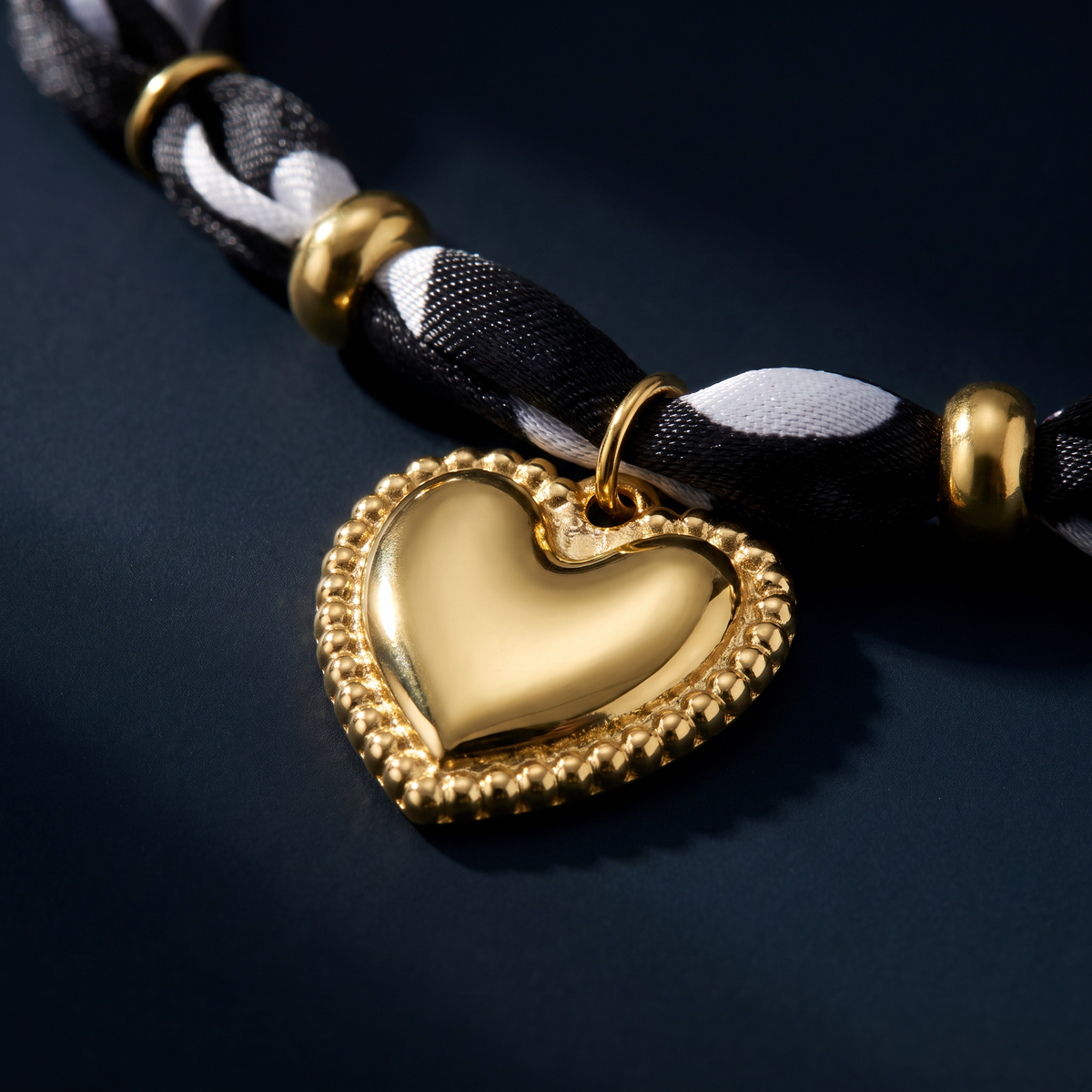 Collier cœur doré à pois sur cordon tressé, motif en gros plan