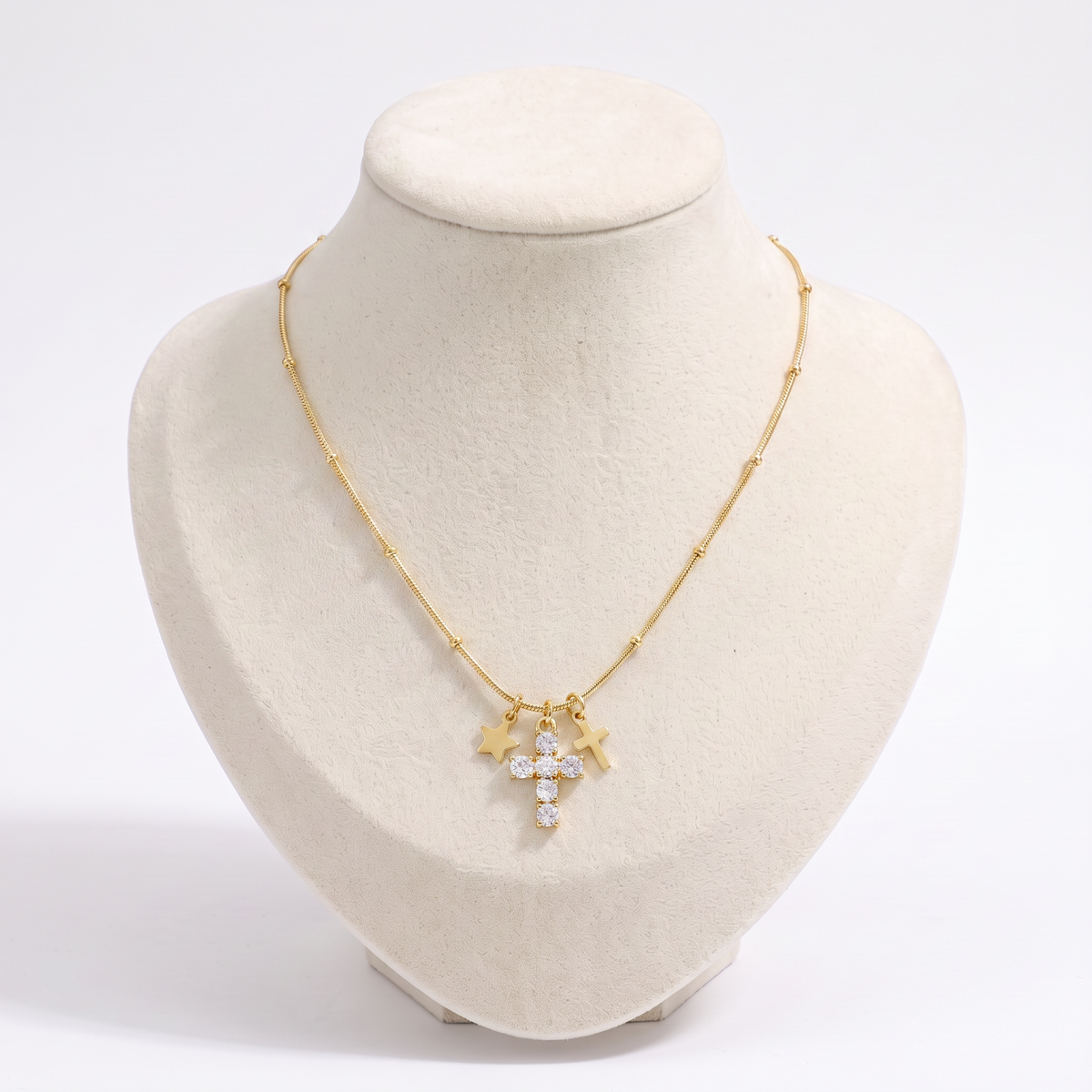 Collier croix et étoile à strass, vue de face, doré