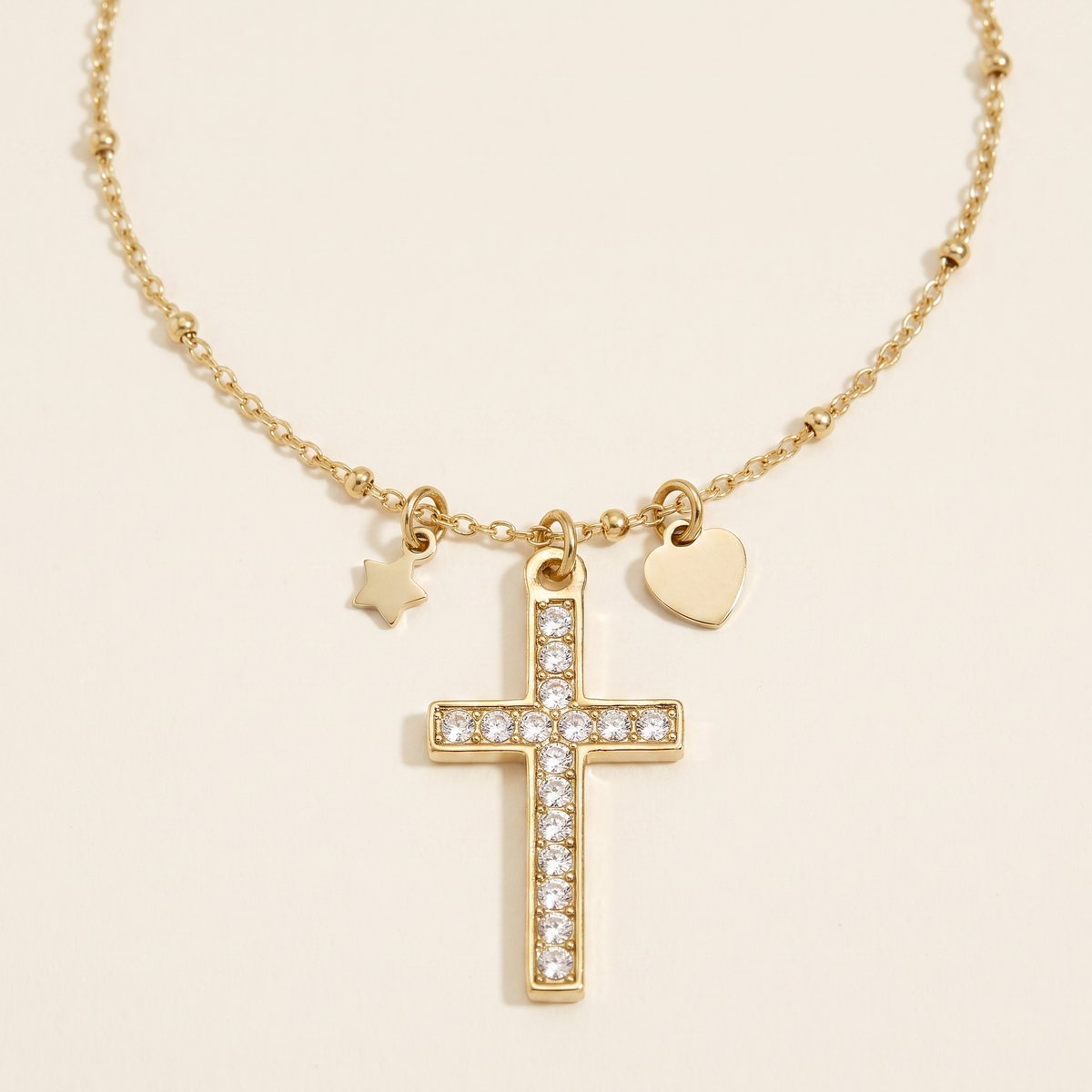 Collier croix, cœur et étoile à strass, détail du motif, doré