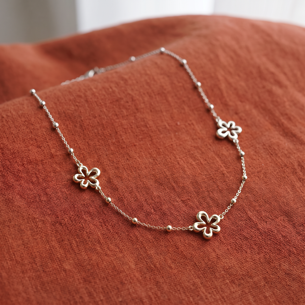 Collier charms fleur à motif ajouré, porté en tenue, argenté