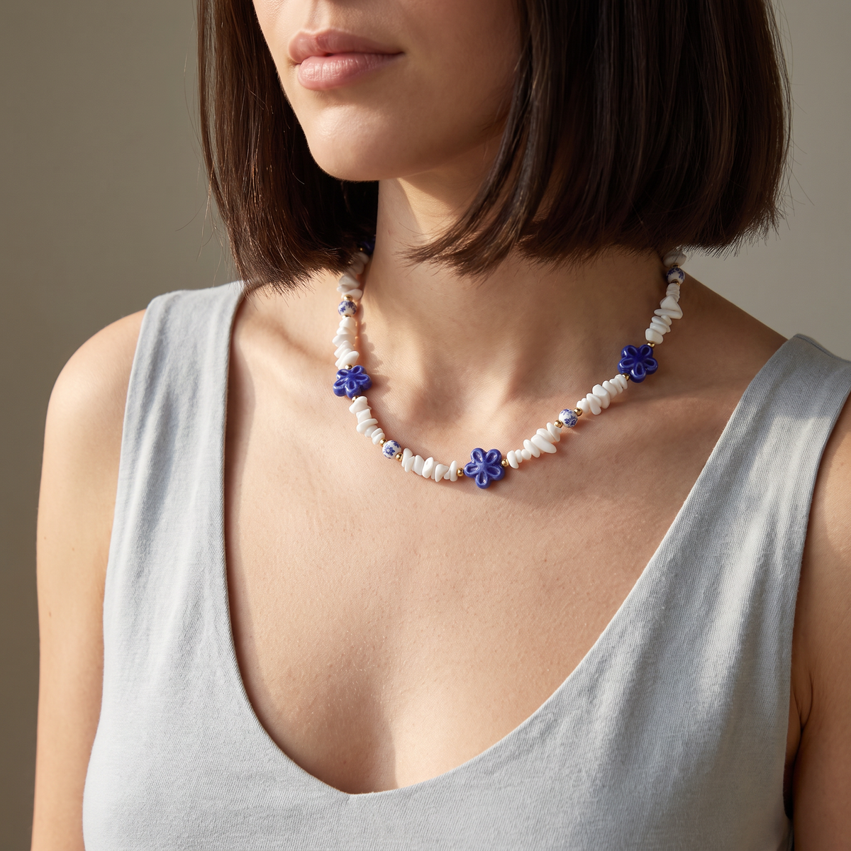 Collier fleur bleu en perles, porté mi-corps