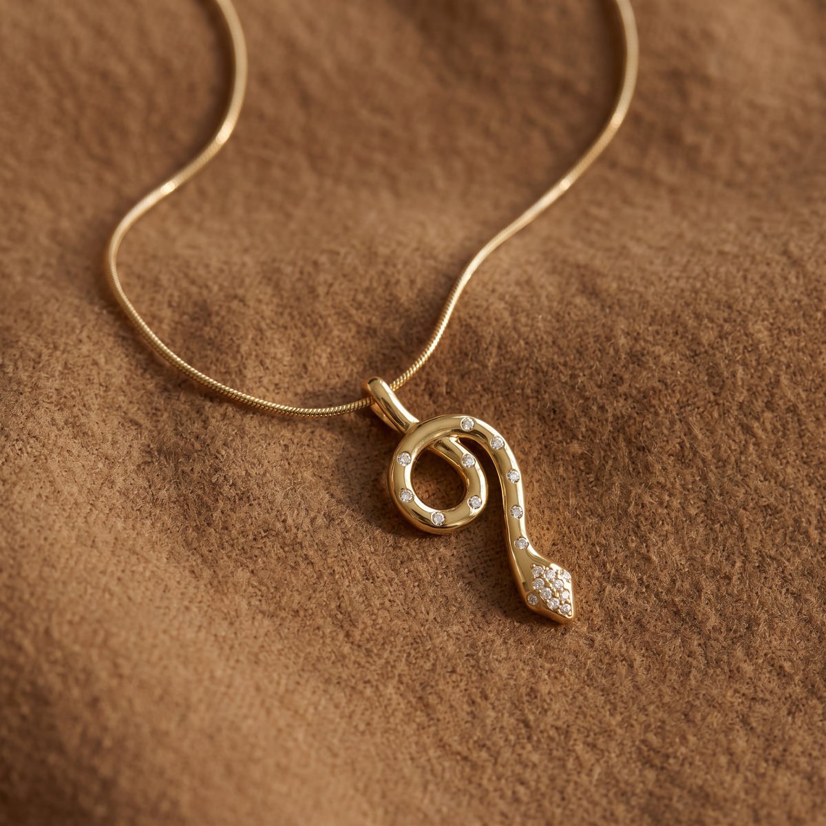 Collier ras de cou serpent à breloques, porté en tenue, doré