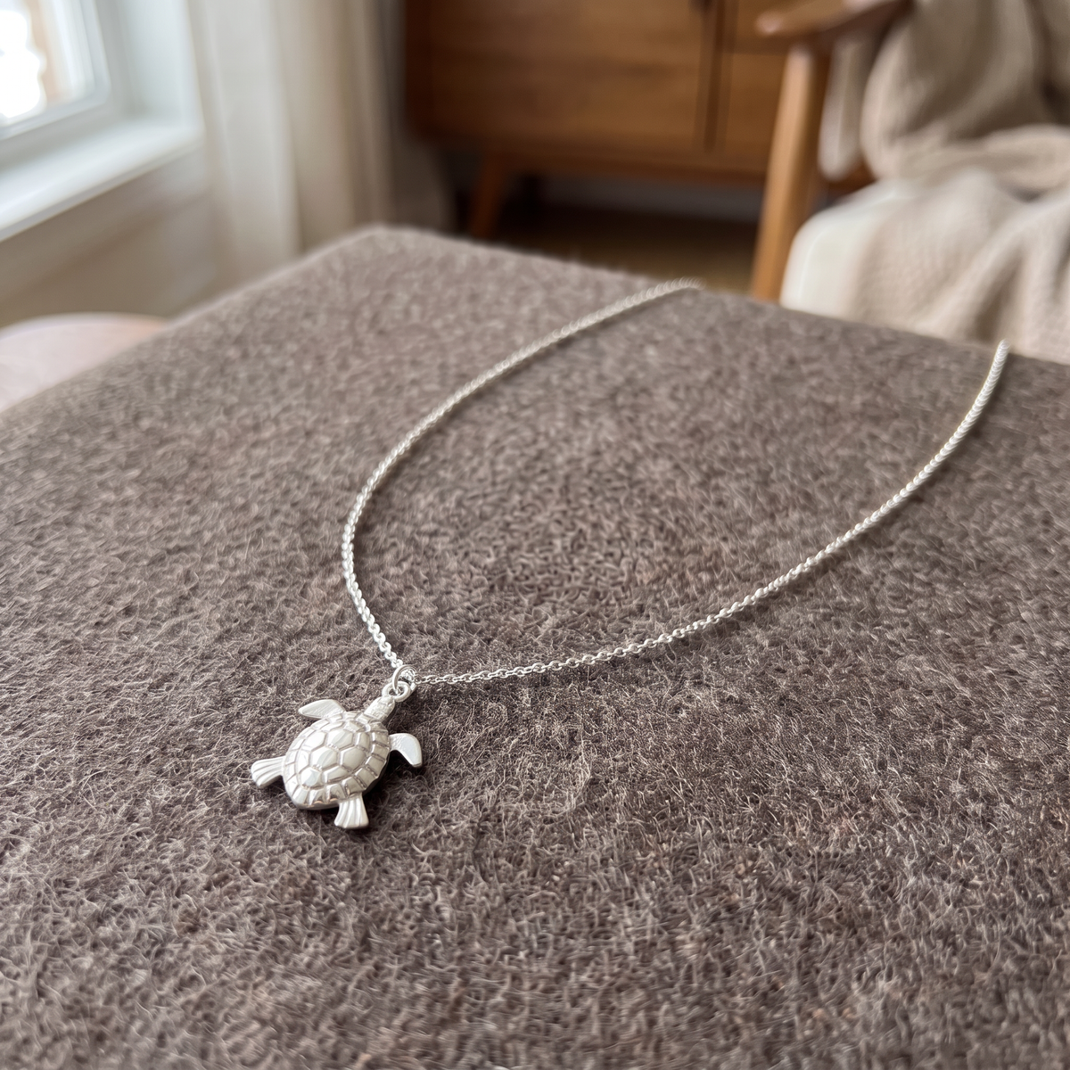 Collier tortue maille fine, porté en tenue, argenté