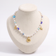 Collier ras de cou coquillage doré à breloques, vue de face