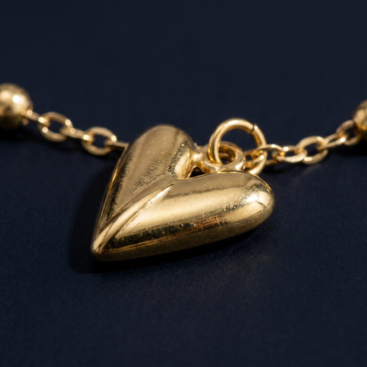 Collier charms cœur et trèfle doré, motif en gros plan