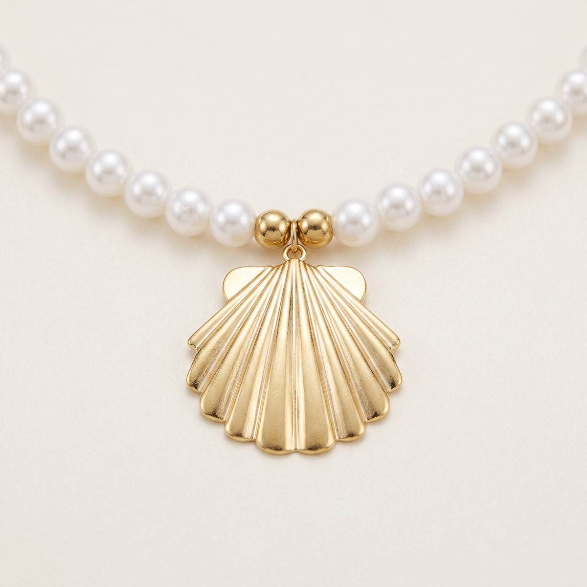 Collier coquillage doré à breloques en perles nacrées, détail du motif