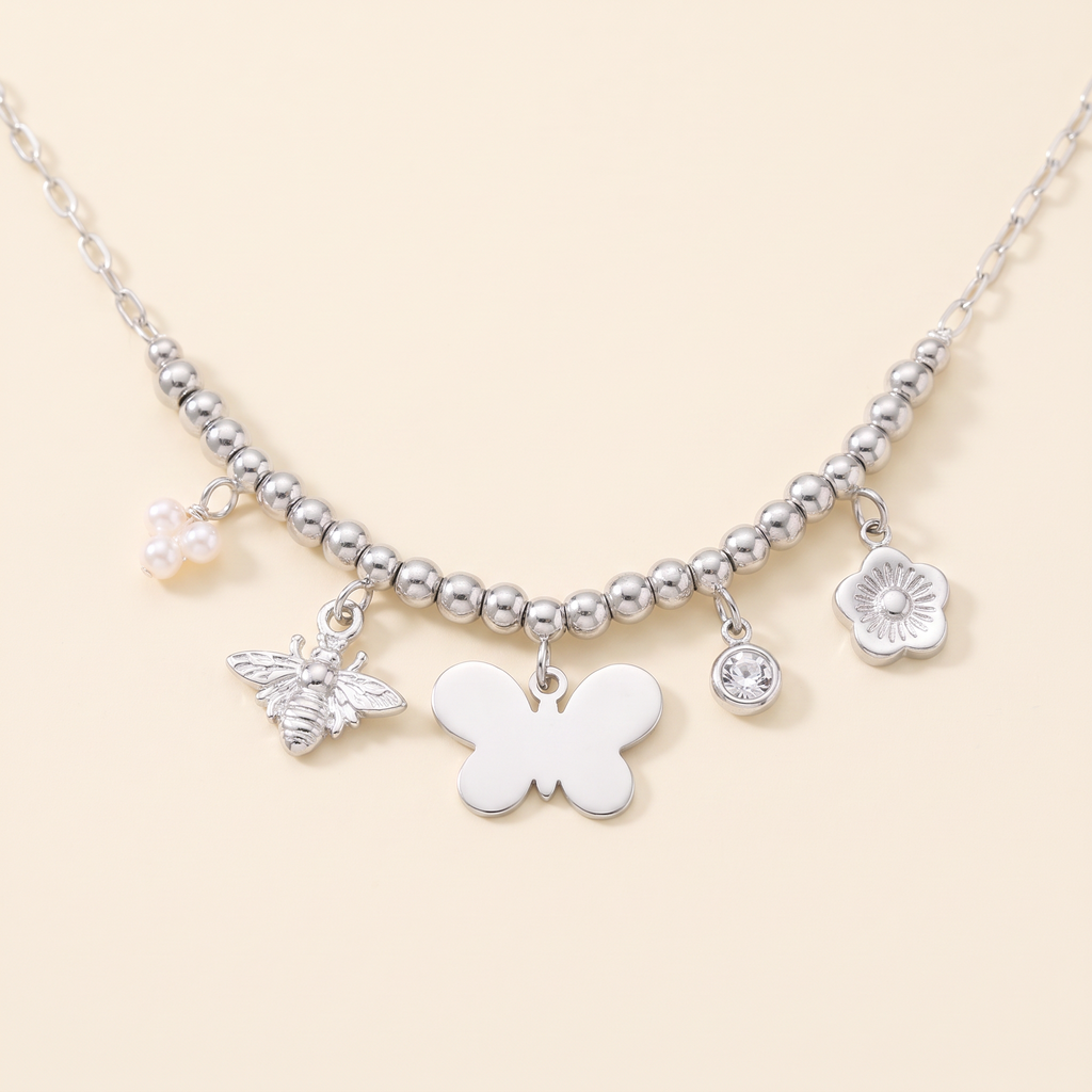 Collier charms fleur et papillon, détail du motif, argenté